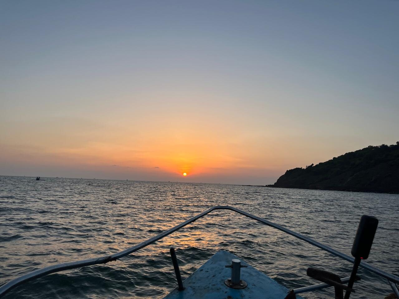 Orange sunset over the sea from a boat