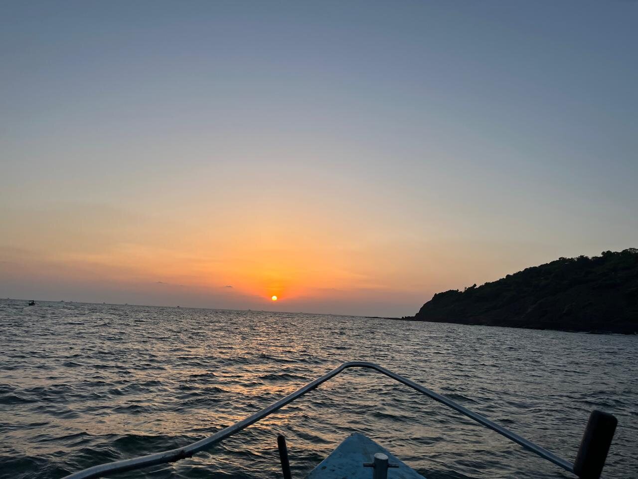 Sunset behind a coastal headland